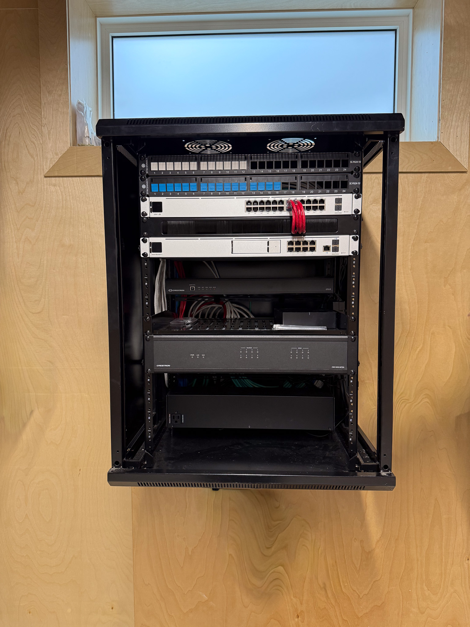 Custom AV installation showcasing professional equipment rack and wiring