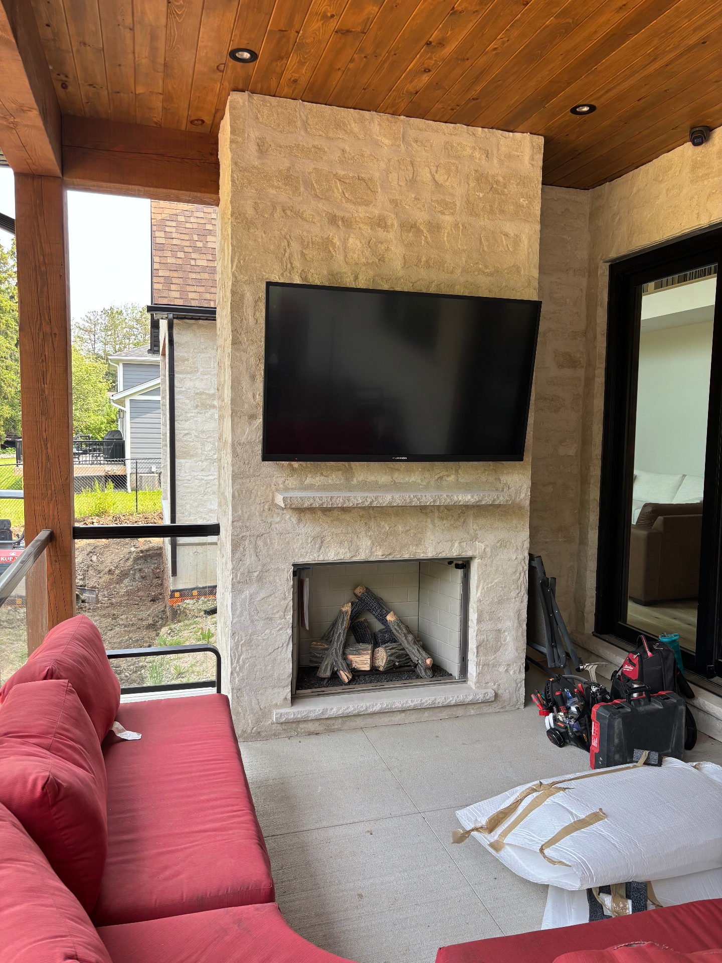 Outdoor TV installation above an exterior fireplace at a Blue Mountains home